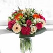 As if capturing a joyful celebration in a single moment, this bouquet glows with the spirit of Millbank's vibrant community. At its heart, radiant orange gerberas seem to echo the warmth of a riverside sunset, joined by blush pink roses and velvety, magenta carnations that add layers of affectionate intensity and visual delight. Soft peach gerberas and creamy ivory roses temper the exuberance with gentle elegance and a whisper of tenderness. The structure, held together by crisp, glossy greens inspired by walks along Millbank's riverfront pathways, frames each blossom with a sense of abundant freshness and contemporary style. Illuminated by a wash of bright, natural light-much like the soft glow inside Millbank's celebrated galleries-every bloom radiates with dimension and vitality, highlighting each petal's delicate detail. Whether to mark a special moment, send cheer to a loved one in the heart of Millbank, or simply fill a home with happiness, this bouquet embodies a burst of joy, expertly composed and infused with the love and artistry unique to local florists.